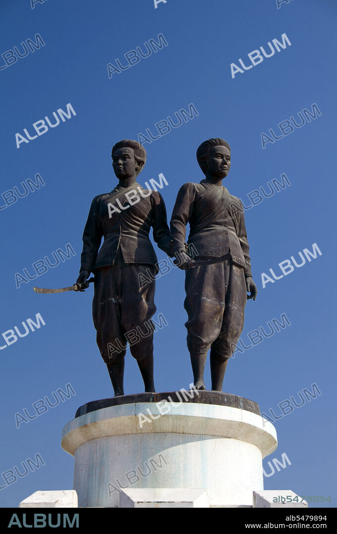 Rama I's Chakri dynasty met its first great test in the massive Burmese invasion of 1785. King Bodawpaya of Burma (1781-1819) sent more than 100,000 troops in five armies against Siam. The Burmese forces that invaded southern Thailand enjoyed initial success but were halted at Thalang, in central Phuket, by the bravery of the local defenders. Two sisters - Chan, or 'Date Plum', and Muk, or 'Pearl', the widow and sister-in-law of the late governor, organised the resistance by ordering the local women to cut their hair short and dress as men. When the Burmese commander saw the defences, he was fooled into thinking Thalang had many more soldiers than was actually the case! The court in Bangkok, on learning of the two sister's brave action, distinguished them with royal titles. Miss Chan was named Thepkasatri, or 'Angelic Queen', and Miss Muk became Si Sunthorn, or 'Goddess of Beauty'. Today they are still seen as local folk heroes and spiritual guardians of the island. They stand together on the Heroine's Monument at Thepkasatri Road, brandishing long swords towards any future invaders of the island.
