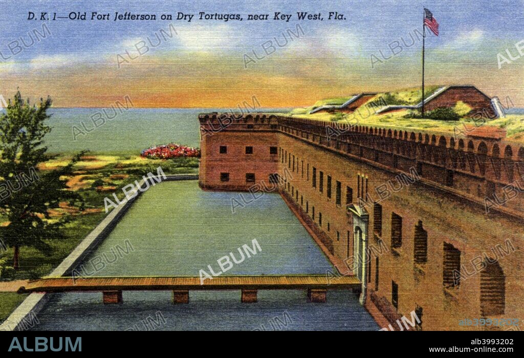 Old Fort Jefferson on the Dry Tortugas, near Key West, Florida, USA, 1940. Postcard. Exterior view of the fort. A bridge crosses a moat to the entrance. The ocean is visible beyond the fort. The Dry Tortugas are a group of islands off the Florida Keys. They occupy a stategic position able to threaten shipping in the Gulf of Mexico and as a result, in 1846, the US government began building a fort on one of the islands, Garden Key. Fort Jefferson was designed to be a three-tiered fortress with 420 guns, but was never completed. It served as a military prison and four of the conspirators in the assassination of President Abraham Lincoln were incarcerated there. By 1888 the fort's military usefulness had declined and the expense of maintaining it in the face of the hostile climate and frequent hurricanes caused the military to hand it over to the Marine Hospital Service for use as a quarantine station.