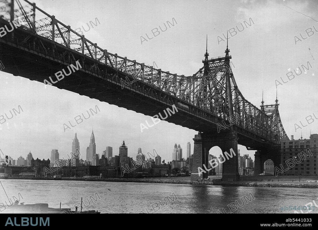 The Grandeur Of Gotham -- As seen from Long Island City, looking under the Queensboro Bridge where it crosses Welfare Island. The city ***** be seen in the left foreground. The sky scrapers, from left to right, are the News Building, the Empire State. Building, the Chrysler building, the new Waldorf-Astoria Hotel and the Grand Central building. May 24, 1931.