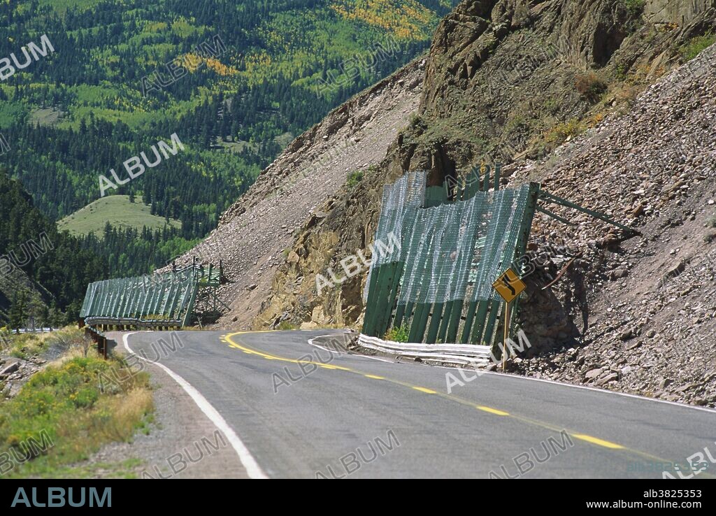 To prevent dangerous rockslides along these high alpine roads, fence barriers are placed along the steepest hillsides in the hopes of minimizing road hazards. Wolf Creek Pass, Rio Grande, Colorado.
