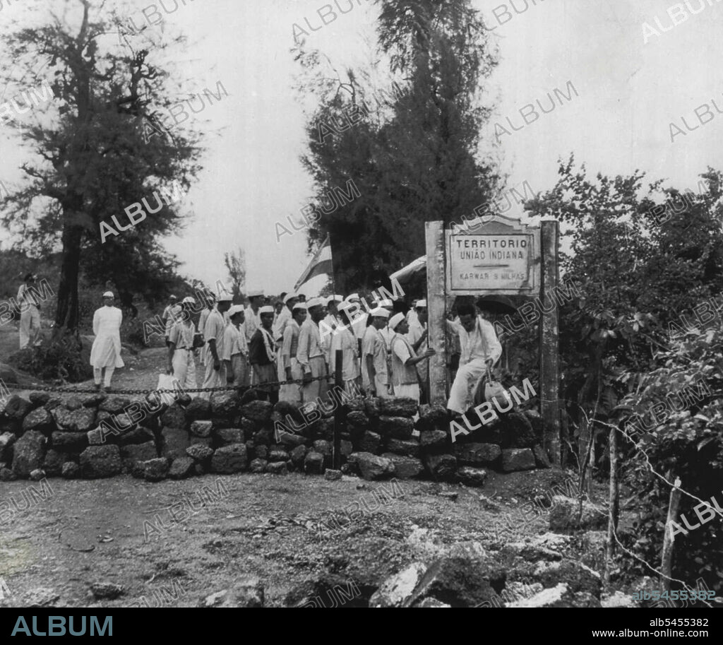 Liberation Army, Crosses Goan Border -- Anthony Desouse, 25-year-old former Bombay clerk turned agitator, climbs over stone barrier marking the India-Goa border as he leads a group of supporters into Portuguese territory on India's Independence Day last Sunday. The group, supporting the Indian campaign to merge the Portuguese enclaves in India into Indian territory, was arrested after marching several miles past the frontier. August 21, 1954. (Photo by AP Wirephoto).