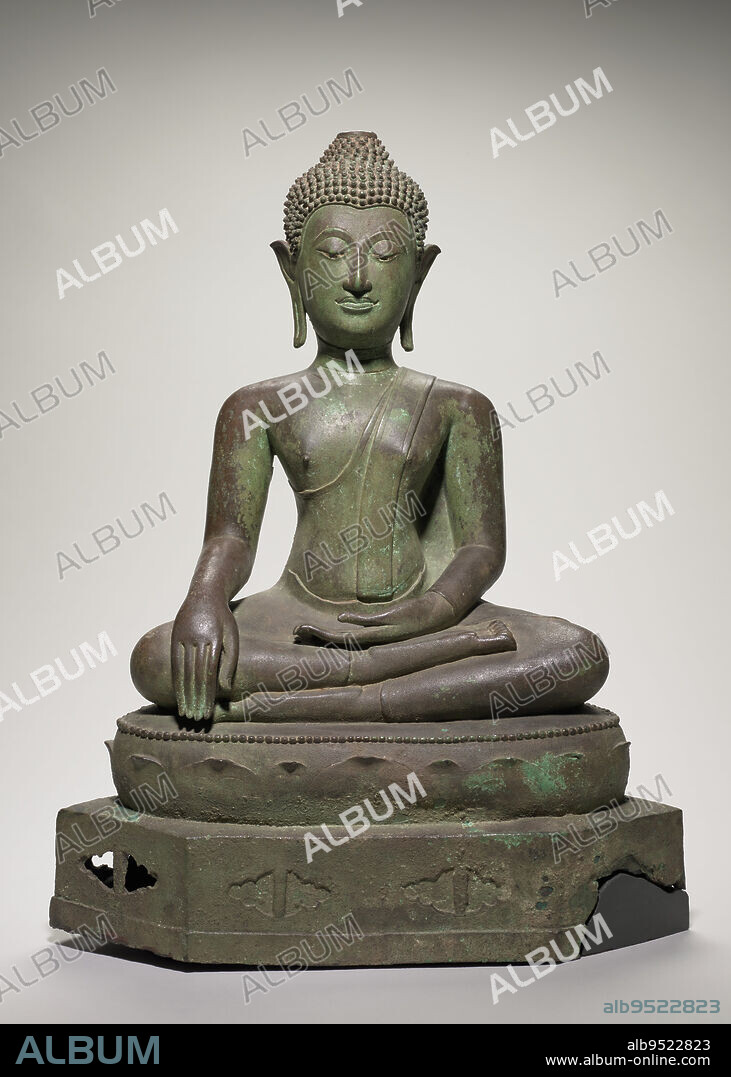 Buddha subduing Mara, 15th century, 24 3/4 in. (62.87 cm), Bronze, enamel, Thailand or Laos, Chieng San style, This sculpture captures the moment of the Buddhas enlightenment: the defeat of Mara, lord of the realm of desire and cause of human suffering. In a gesture called bhumisparsamudra, his right hand gently calls the earth to witness the momentous occasion. Thai sculptors often forgo the narrative details of the event; instead, they economically convey its essence. The Buddhas downcast eyes indicate deep meditation, a 'lion-like' body resists the armies of temptation, and the face, now free from suffering, radiates bliss. Likely created in central Thailand, the sculpture demonstrates how Thai artists frequently fused regional tastes. Its lotus-cushion throne and broad shoulders reflect developments in the northern Thai kingdom of Lan Na (12001700), while the oval head, U-incised chin, heart-shaped hairline, and tubular limbs reflect developments in the southern Sukothai Kingdom (12381438).