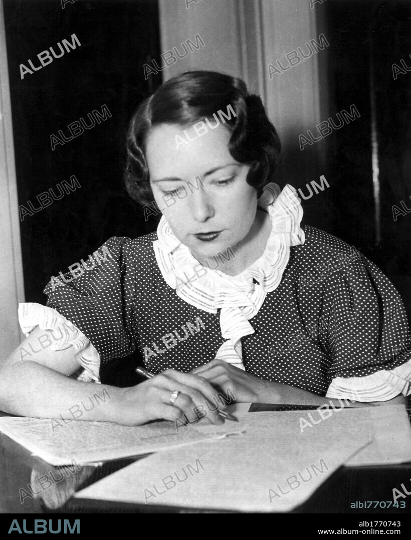 Margaret MItchell writing. The American writer Margaret Mitchell writing sitting at a table. 1936.