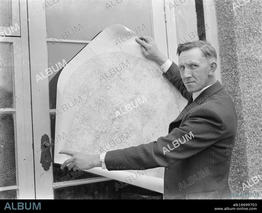 Dr Hugh Percival Wilkins PhD FRAS 1896 - 1960 was a British engineer by profession but most notably known as an amateur astronomer and particularly as a moon mapper . In his life he has created a number of moon maps , doing much of the observing from his home . In this photo Mr Hugh Percy Wilkins , at his home in Barnehurst , Kent , shows off pieces of a map of the moon that he has created . 1938.
