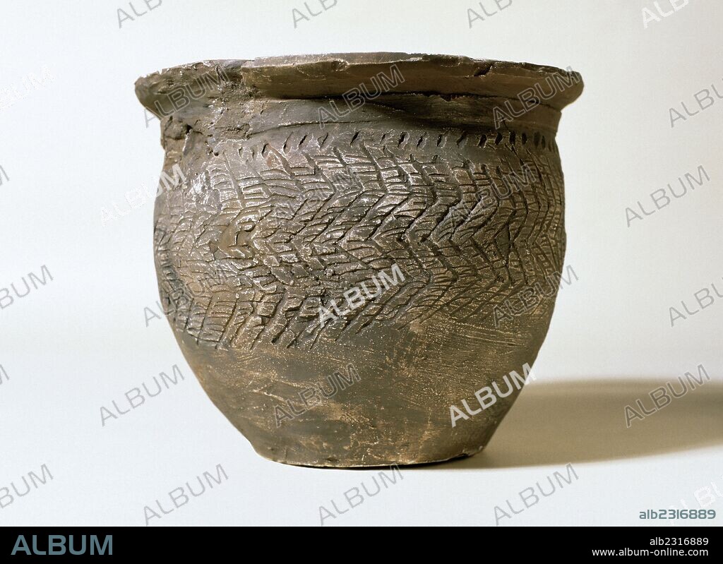 ARTE PREHISTORICO. EDAD DE LOS METALES. ESPAÑA. EDAD DEL HIERRO. Siglos VII-VI a. C. "OLLA DE TERRACOTA GRIS". Con ligeras incisiones de líneas inclinadas, reconstruida en buena parte. Procede de una sepultura del "Turó de les Mentides", cerca de Manlleu (comarca de Osona, Cataluña) y a unos 100 m. de unos silos. Museu Episcopal de Vic. Provincia de Barcelona. Comarca de Osona. Cataluña.
