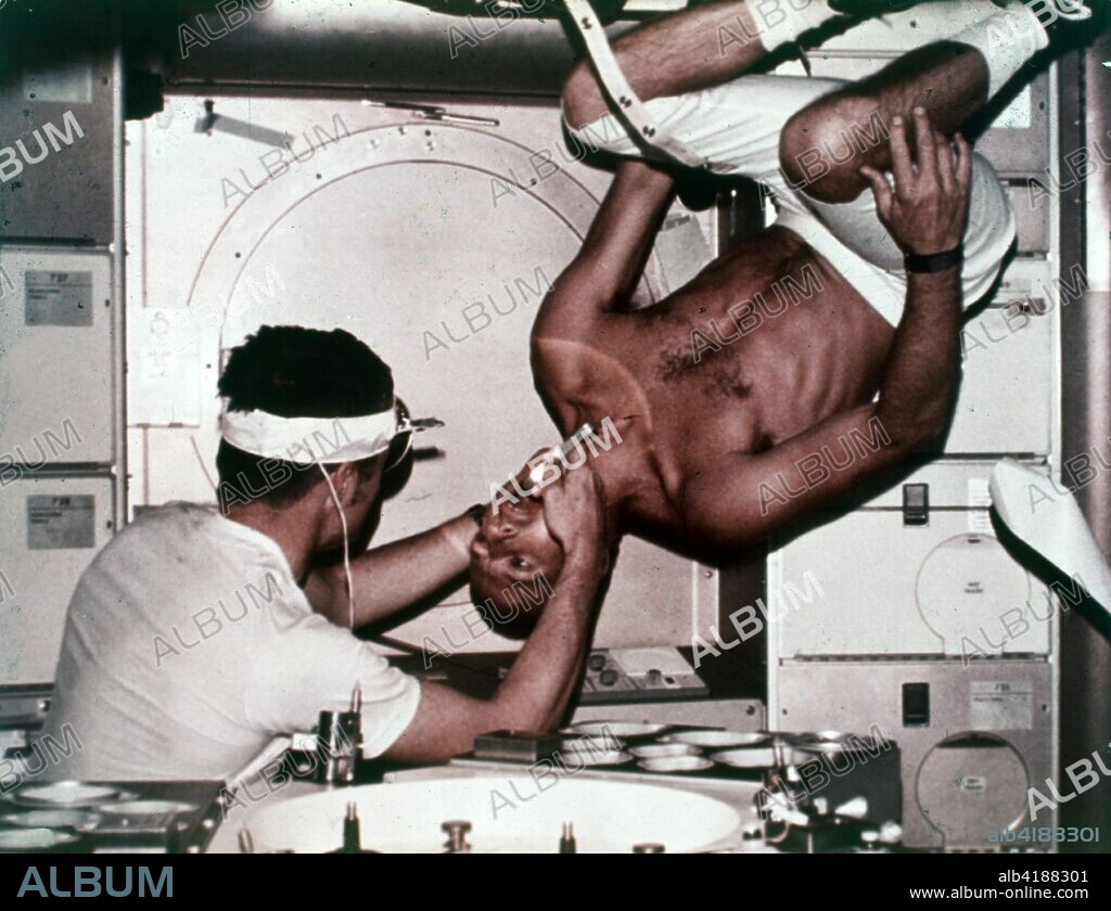 Kerwin examining Conrad on Skylab 2, 1973. Skylab 2 commander Pete Conrad undergoes a dental examination by medical officer Joseph Kerwin in zero gravity. In the absence of an examination chair, Conrad rotated his body to an upside down position to facilitate the procedure. The Skylab space station, first launched in May 1973, and was occupied in succession by three teams of three crewmembers. These crews orbited the Earth and performed nearly 300 experiments.