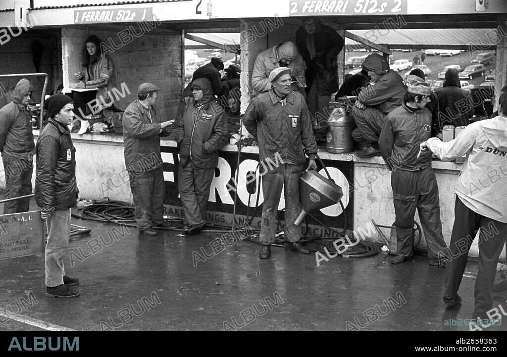 Works Ferrari mechanics waiting in the rain to refuel their car at the pits, BOAC 1000kms, Brands Hatch, England 12 April 1970.