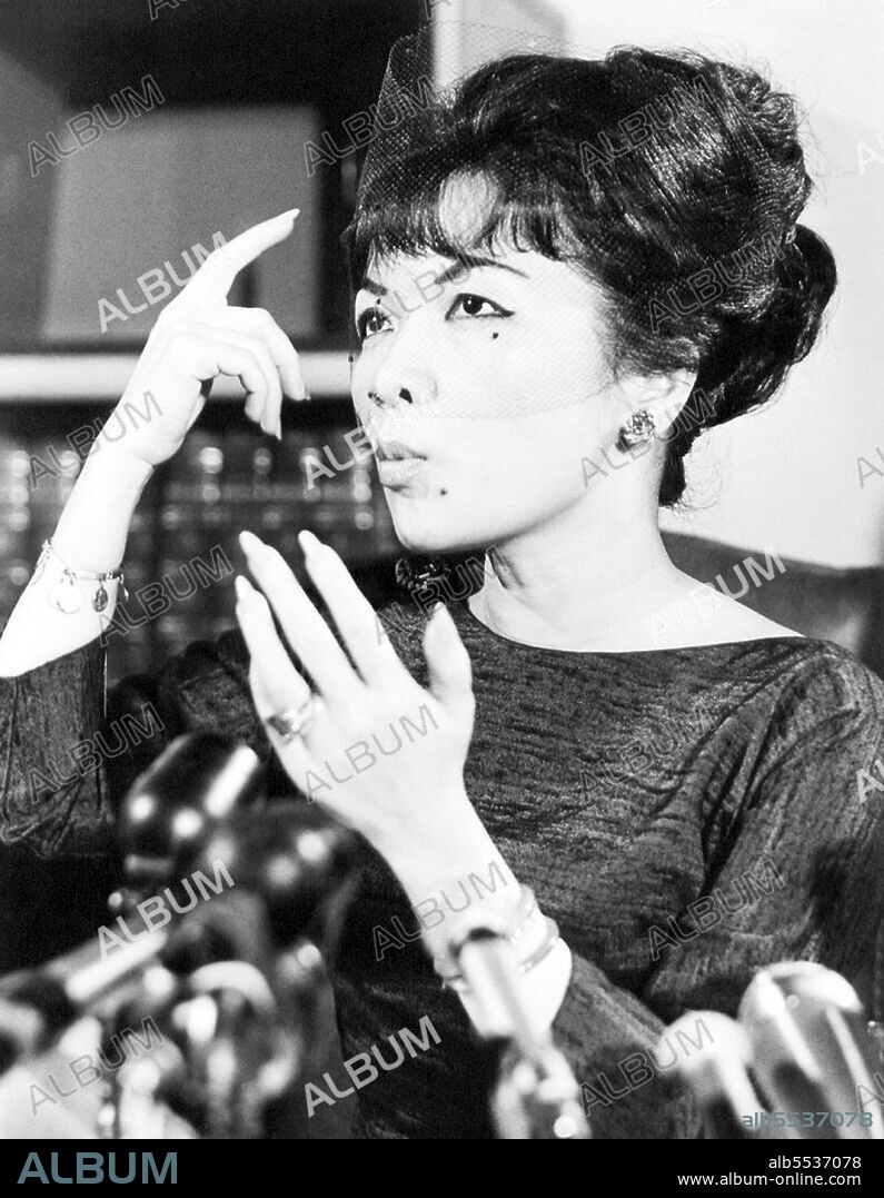 Tran Le Xuan (born April 15, 1924 in Hanoi, Vietnam), popularly known as Madame Nhu but more properly Madame Ngo Dinh Nhu, was considered the First Lady of South Vietnam from 1955 to 1963. She was the wife of Ngo Dinh Nhu, brother and chief adviser to President Ngo Dinh Diem. As Diem was a lifelong bachelor, and because the Nhus lived in the Independence Palace, she was considered to be the First Lady. Diem often appointed relatives to high positions, so her father became the ambassador to the United States while her mother, a former beauty queen, was South Vietnam's observer at the United Nations. Two of her uncles were cabinet ministers. Madame Nhu was chauffeured in a black Mercedes and wore a small diamond crucifix. She also wore form-fitting apparel so tight that one French correspondent suggestively described her as, 'molded into her .. dress like a dagger in its sheath'. On formal occasions, she wore red satin pantaloons with three vertical pleats, which was the mark of the highest-ranking women of the imperial court in ancient Annam.  After the overthrow of the Diem government in 1963, Madame Nhu went into exile in France and died at Rome, Italy, in 2011.