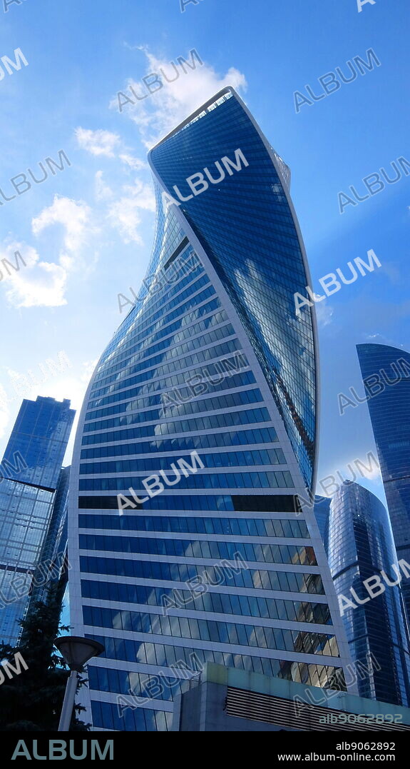 The Evolution Tower skyscraper, located in the Moscow International Business Center in Moscow, Russia. The 55-story office building has a height of 246 metres (807 ft) and a total area of 169,000 square metres (1,820,000 sq ft). Noted in Moscow for its futuristic DNA-like shape, the building was designed by British architect Tony Kettle in collaboration with University of Edinburgh's Professor of Art Karen Forbes. Construction of the tower began in 2011 and completed in late 2014.