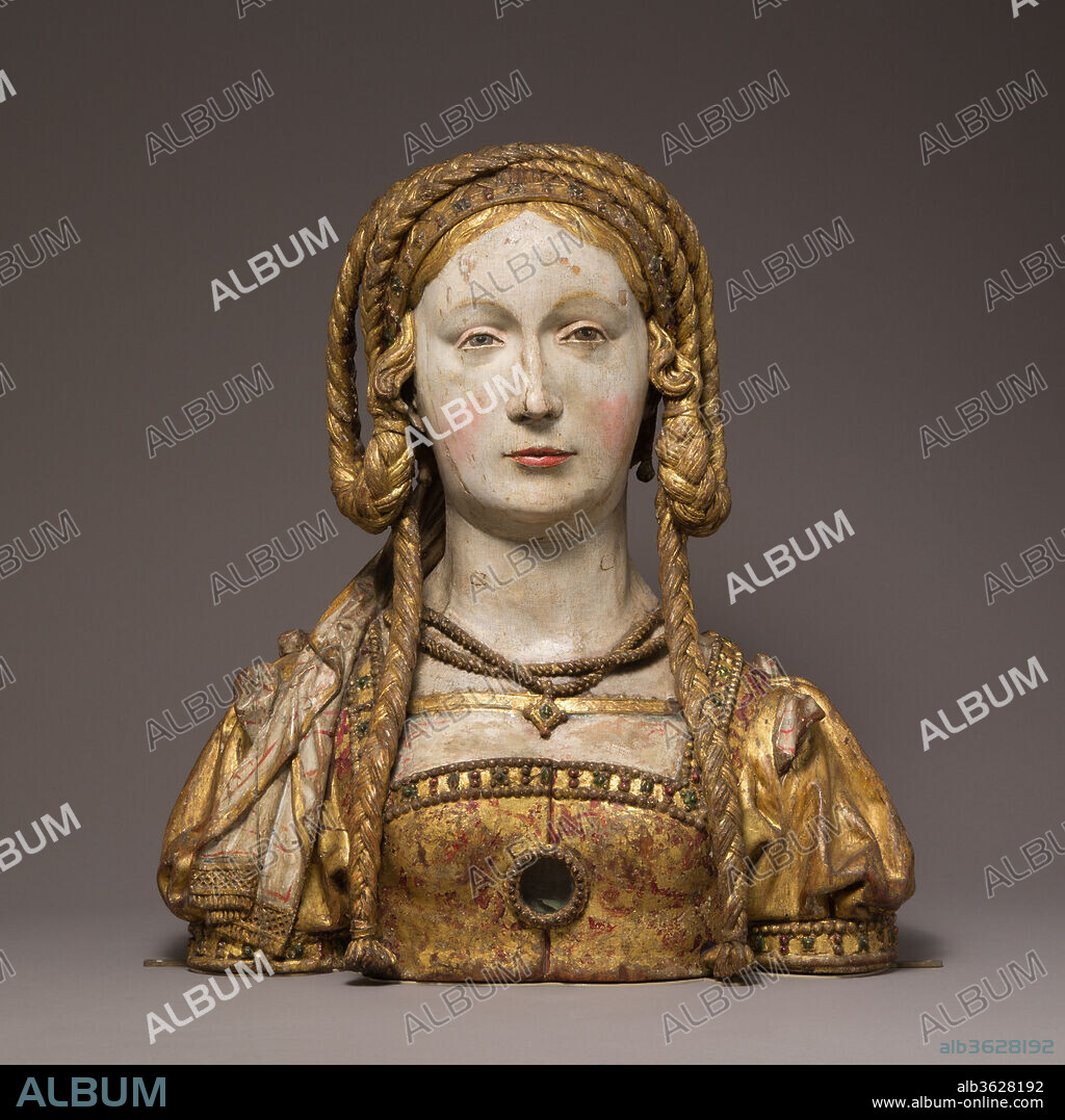Reliquary Bust of Saint Balbina. Culture: South Netherlandish. Dimensions: Overall: 17 1/2 x 16 x 6 1/4 in. (44.5 x 40.6 x 15.9 cm). Date: ca. 1520-30.
Medieval reliquaries often took the form of the body parts they were created to contain. Bust reliquaries for the skulls of saints were placed on or near altars and, by the late Middle Ages, were assembled in large numbers in some church sanctuaries, from Cologne in the north to Ubeda in southern Spain. These examples, with elaborate jewels, beautifully braided hair, and richly decorated gowns, probably represent companions of the virgin martyr Saint Ursula, believed to have been eleven thousand in number. The small glazed medallions resembling jewelry once displayed additional relics. On particular feast days, such busts could be carried in processions.