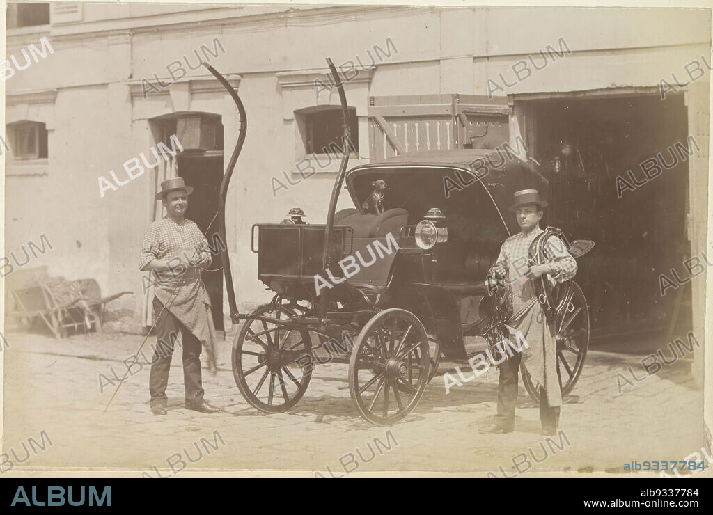 Two men and a carriage at a carriage house in France, Part of Photo album of a French amateur photographer with shots of a family, distillery Delizy & Doistau Fils, the army and places of interest in France., anonymous, France, c. 1900 - c. 1910, paper, albumen print, height 104 mm × width 160 mm.