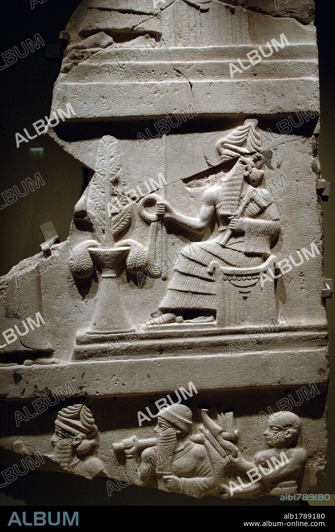 ARTE MESOPOTAMICO. SUMERIO. TERCERA DINASTIA DE UR. Fragmento de la ESTELA DE UR-NAMMU en piedra calcárea con la representación del DIOS SIN SENTADO EN UN TRONO. Fechada en el s. XXI a. C. Exposición Babilonia. Museo del Louvre. París. francia.