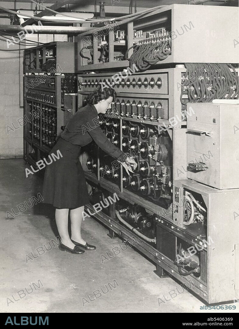 A female technician operating a bombe decyption machine in the US, May 1945. The bombe was an electro-mechanical device used by British and American cryptologists to help decipher German Enigma-machine-encrypted secret messages during World War II. The initial design of the bombe was produced in 1939 at the UK Government Code and Cypher School (GC&CS) at Bletchley Park by Alan Turing, with an important refinement devised in 1940 by Gordon Welchman.