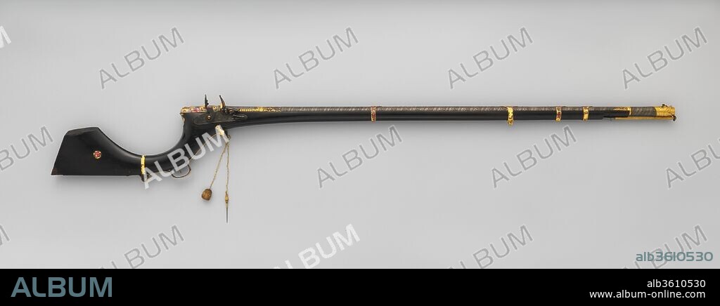Flintlock Gun. Culture: Indian, Sindh (now Pakistan); lock, British. Dimensions: L. 58 7/8 in. (149.5 cm); L. of barrel 42 3/4 in. (108.6 cm); Cal. .56 in. (14.0 mm); Wt. 9 lb. 11 oz. (4393 g). Date: second quarter of the 19th century.
Guns of this type, with sharply curved flaring butts and mounts in enameled gold of Iranian manufacture, are typical of Sind, now a province of southern Pakistan. The British lock is inscribed "H. M.," possibly referring to the well-known London gunmaker Harvey Walklate Mortimer (1753-1817). It may be a remnant of the firearms given to the mirs, rulers of Sind, by the British government. The barrel, possibly made locally, is of boldly patterned Damascus steel. The gilt muzzle is in the shape of a dragon's head, the eyes set with rubies and emeralds.