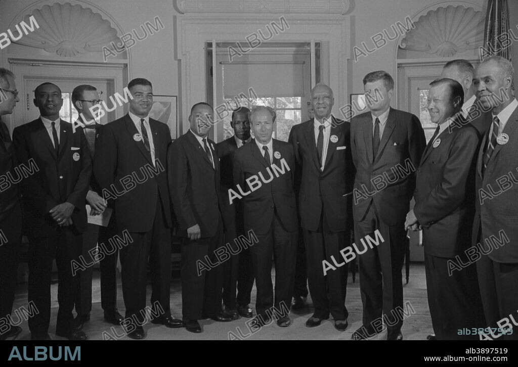 August 28, 1963 - Civil rights leaders meet with President John F. Kennedy in the oval office of the White House after the March on Washington, D.C.. . Photograph shows (left to right): Willard Wirtz (Secretary of Labor); Floyd McKissick (CORE); Mathew Ahmann (National Catholic Conference for Interracial Justice); Whitney Young (National Urban Leage); Martin Luther King, Jr.(SCLC); John Lewis (SNCC); Rabbi Joachim Prinz (American Jewish Congress); A. Philip Randolph, with Reverend Eugene Carson Blake partially visible behind him; President John F. Kennedy; Walter Reuther (labor leader), with Vice President Lyndon Johnson partially visible behind him; and Roy Wilkins (NAACP).