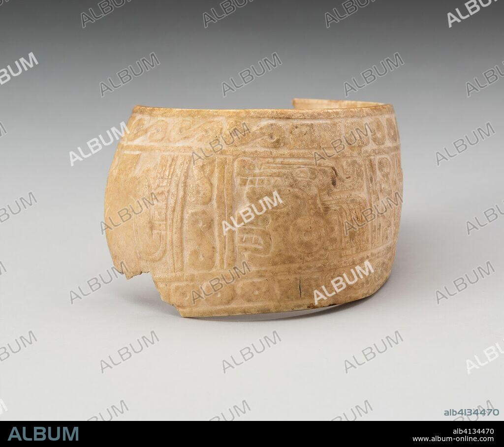 Shell, Possibly an Arm Band, Incised with Profile Head Framed by Geometric Motifs (Frament). Possibly Mixtec; Oaxaca or Guerero, Mexico. Date: 1000-1400. Dimensions: 6.7 x 8.9 cm (2 5/8 x 3 1/2 in.). Shell. Origin: Guerrero state.