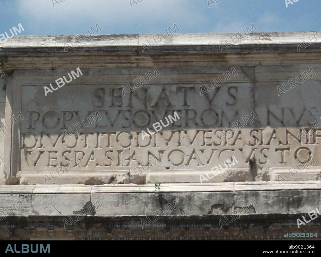 Latin Inscription detail from The Arch of Constantine, a triumphal, or victory arch in Rome. It is positioned between the Collosseum and the Palatine Hill. It commemorates Emperor Constantine's victory in the Battle of Milvian Bridge in the early 4th century AD. It was dedicated in 315 AD and features reliefs/friezes documenting previous Emperors and victory figures.