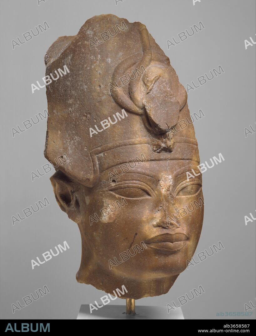 Amenhotep III in the Blue Crown. Dimensions: h. 35 cm (13 3/4 in); face only: h. 12.8 cm (5 1/16 in); w. 12.6 cm (4 15/16 in). Dynasty: Dynasty 18. Reign: reign of Amenhotep III. Date: ca. 1390-1352 B.C..
The facial features of this head of Amenhotep III show the stylistic elements of his later representations: highly arched brows, elongated almond-shaped eyes, and full, sharply outlined lips. The Blue Crown (called the khepresh) was apparently the king's preferred royal headdress and is worn by him in many of his statues and reliefs.