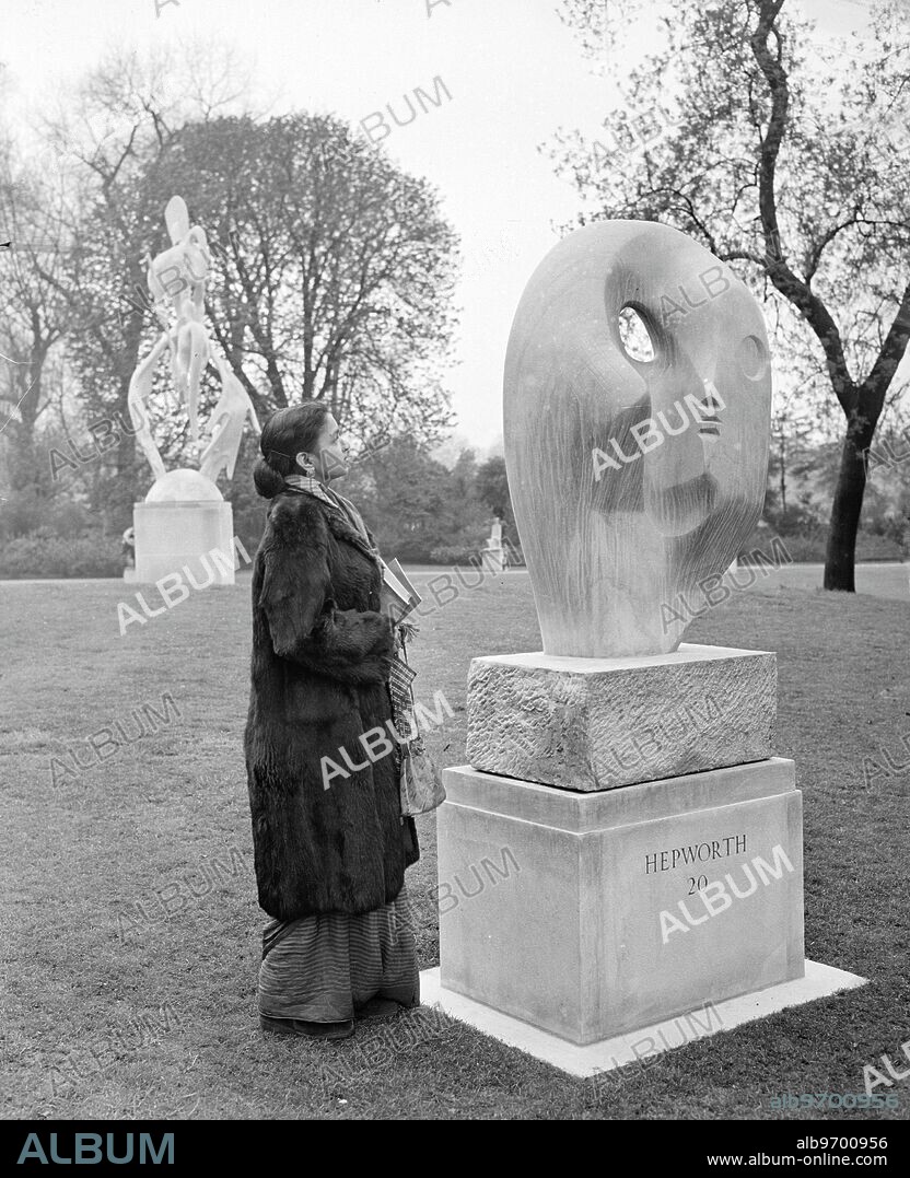 Mrs B Hooja, a student of sculpture from Delhi, looks at " Biolith ", a Blue Ancaster stone sculpture by Barbara Hepworth, on show at the Second International Open Air Exhibition of Sculpture in Battersea Park, London. The Exhibition - the first was held in 1948 - has been organised by the London County Council in Association with the Arts Council of Great Britain. Barbara Hepworth, who has done some work for the Festival of Britatin's South Bank Exhibition, was born in Wakefield, Yorkshire, in 1903, and she now lives in Cornwall. 7 May 1951.