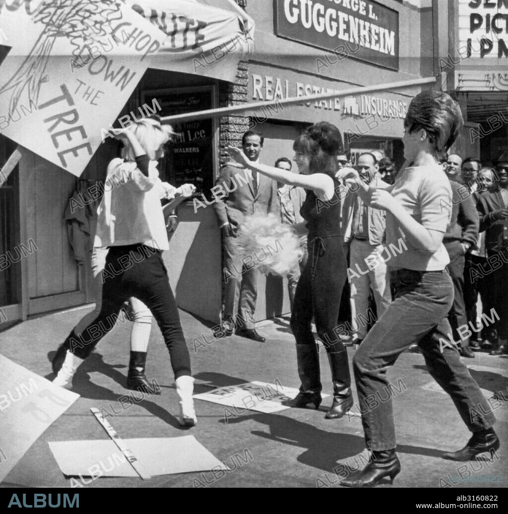 San Francisco, California: March 30, 1966 The amateur topless dancers have muscled in on the pros, and 14 professional topless dancers are now picketing the Peppermint Tree. They were given final notice after last night's show and are being replaced by amateurs. Two striking 'topless' professionals (center and right) grab a blonde wig from one of the amateur performers who is doing their job for free.