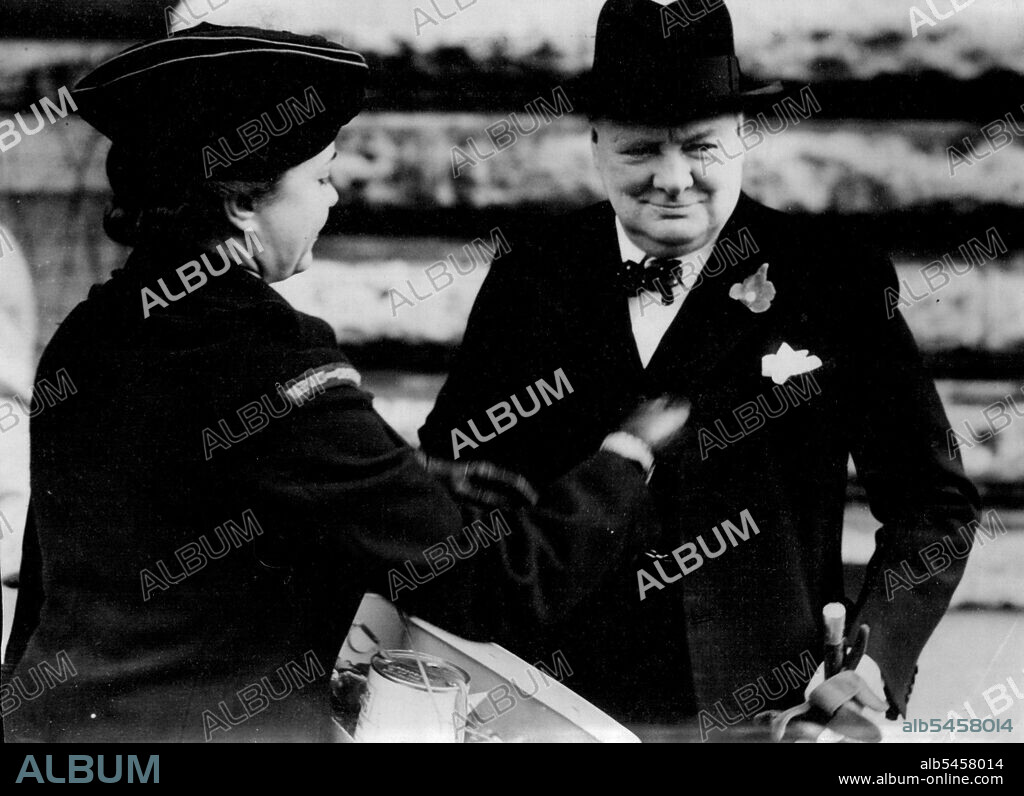 The Prime Minister's Poppy -- Mr. Churchill stops on his way to the House of Commons to contribute to the Earl Haig Fund and receive his poppy from Miss Reno Chapman, a Civil Defence worker. November 11, 1943.