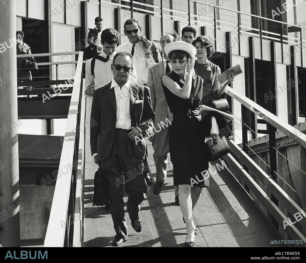 Dino De Laurentis with Audrey Hepburn and Anthony Perkins. The Italian film producer Dino De Laurentis with the actors Audrey Hepburn and Anthony Perkins in Paris. Paris,1962.