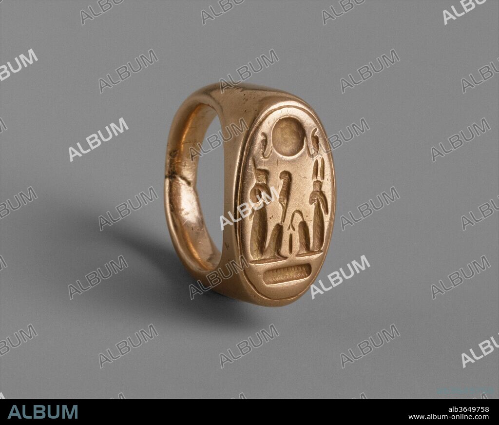 Finger Ring depicting King Akhenaten and Queen Nefertiti as Shu and Tefnut. Dimensions: diam. 2.5 cm (1 in); l. of bezel 2.3 cm (7/8 in). Dynasty: Dynasty 18. Reign: reign of Akhenaten. Date: ca. 1353-1336 BC.
This ring was found at Amarna. The hieroglyphs may be read as an ideogram. The two seated figures are probably Akhenaten (left) and Nefertiti (right) as the deities Shu (air as indicated by the feather he holds) and Tefnut (moisture). They were father and mother of the earth and sky, which are symbolically represented by the earth hieroglyph (below) and by the sun disk flanked by two sacred cobras (above).