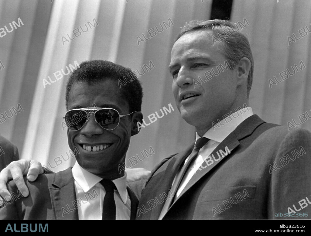 Entitled: "Author James Baldwin and actor Marlon Brando." The March on Washington for Jobs and Freedom was one of the largest political rallies for human rights in United States history and called for civil and economic rights for African-Americans. Estimates of the number of participants varied from 200,000 to 300,000; observers estimated that 75-80% of the marchers were black. The march is credited with helping to pass the Civil Rights Act (1964) and preceded the Selma Voting Rights Movement which led to the passage of the Voting Rights Act (1965). James Arthur Baldwin (August 2, 1924 - December 1, 1987) was an African-American novelist, essayist, playwright, poet, and social critic. He made a prominent appearance at the Civil Rights March on Washington, D.C. on August 28, 1963, with Belafonte and long-time friends Sidney Poitier and Marlon Brando. The civil rights movement was hostile to homosexuals. The only known gay men in the movement were James Baldwin and Bayard Rustin. Marlon Brando, Jr. (April 3, 1924 - July 1, 2004) was an American actor. He is hailed for bringing a gripping realism to film acting, and is widely considered to be one of the greatest and most influential actors of all time.