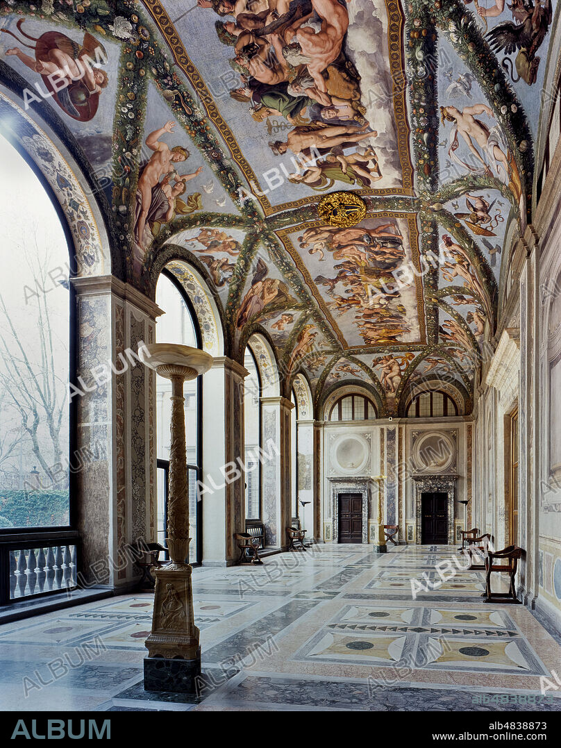 Rome, Villa Farnesina: view of the Loggia of Cupid and Psyche.. The Loggia takes its name from the decoration frescoed on the vault by Raphael and his workshop in 1517-18. The frescos represent episodes from the fable of Psyche, narrated in Apuleius Golden Ass, which had already been used in the fifteenth century for nuptial imagery.. To give the space a festive and theatrical feel to it, Raphael also transformed the vault of the Loggia into a pergola, adorned with magnificent hanging festoons, as though the greenery of the gardens had invaded the Villa itself. In the centre he designed two fictive tapestries which depict the concluding scenes: the splendid Council of the Gods, where the unjustly persecuted girl is finally received by the gods with divine complacence, and the Marriage of Cupid and Psyche, the symbolic culmination of the entire cycle.. However, although the general layout of the cycle and planning of the individual scenes and figures are attributed to the intuitive genius of Raphael (proven by a number of autographic sketches), the actual completion of the designs into frescos was carried out by his numerous workshop assistants, including Giovanni Francesco Penni, Giulio Romano and Giovanni da Udine. The latter, in particular, was the creator of the exuberant triumphal festoons.