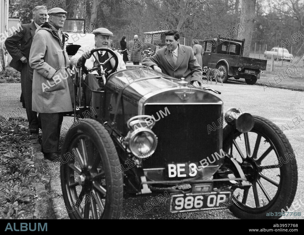 Lord Brabazon in the driver's seat of a vintage car. He was involved in motor racing, and early balloon and aeroplane flight. He obtained the first pilot's license to be issued in the United Kingdom, and was the second Englishman to fly. In 1909 he made the first live cargo flight by airplane, by tying a waste-paper basket to a wing-strut of his Voisin airplane. Then using it as a 'cargo hold', he airlifted a small pig. With Charles Rolls he made an ascent in the first spherical balloon made in England, which was built by the Short Brothers. He was Minister of Transport and later Minister of Aircraft Production under Winston Churchill. After the war he chaired a British Cabinet committee that oversaw the building of a prototype aircraft, the Bristol 167 Brabazon, the largest plane ever built in Britain, which unfortunately never went into production.