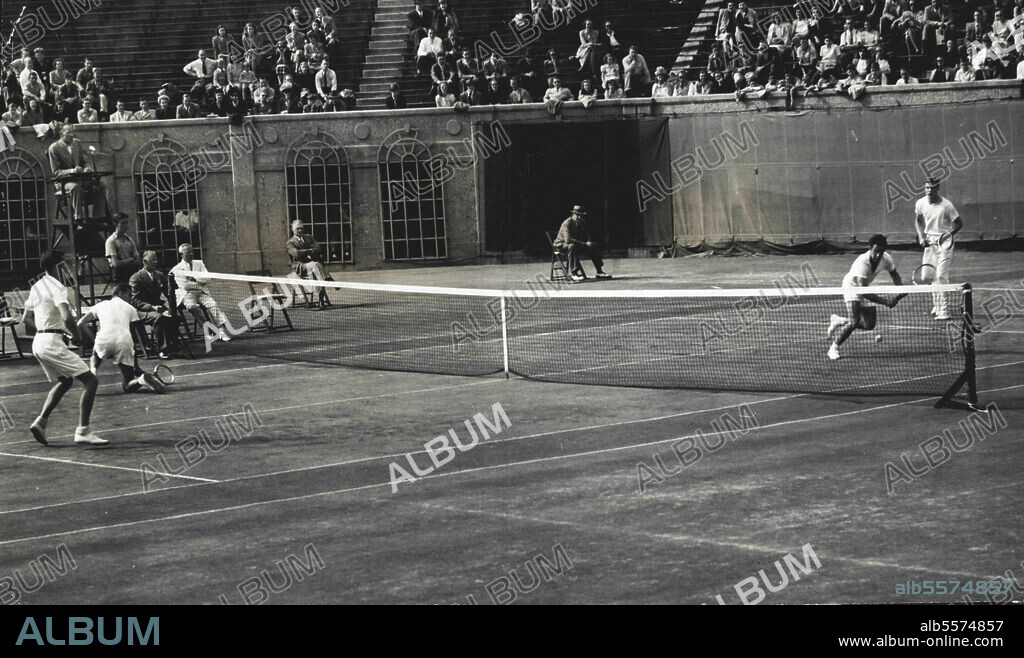 Mulloy Slips In Davis Cup MatchGardnar Mulloy (fore court, left) of Miami, Fla., slips to the ground as he makes a return to Torsten Johansson (backcourt, fore ground) of Sweden in the third game of the second set of their doubles match in the Davis Cup interzone round at Forest Hills, N.Y., September 14. Billy Talbert (forecourt, right) of Wilmington, Del., backs up Mulloy as Lennart Bergelin (backcour, rear) watches Johansson go in for the ball. The U.S. Davis Cup team of Mulloy and Talbert defeated the Swedish team, 3-6, 9-7, 3-6, 6-0, 8-6. September 14, 1946. (Photo by Associated Press Photo).