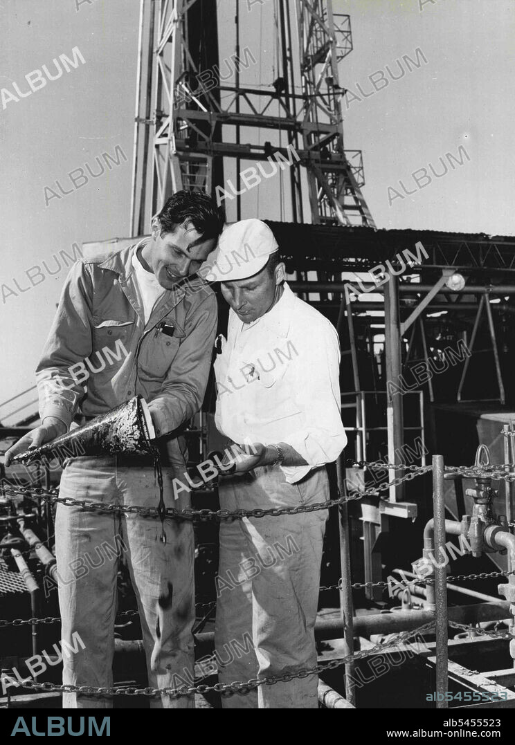 Sam Welker, a Brown Drilling Co. petroleum engineer, and Jack Rice, a tool-pusher, examine an oil sample at the rig at Exmouth Gulf yesterday. June 01, 1954.