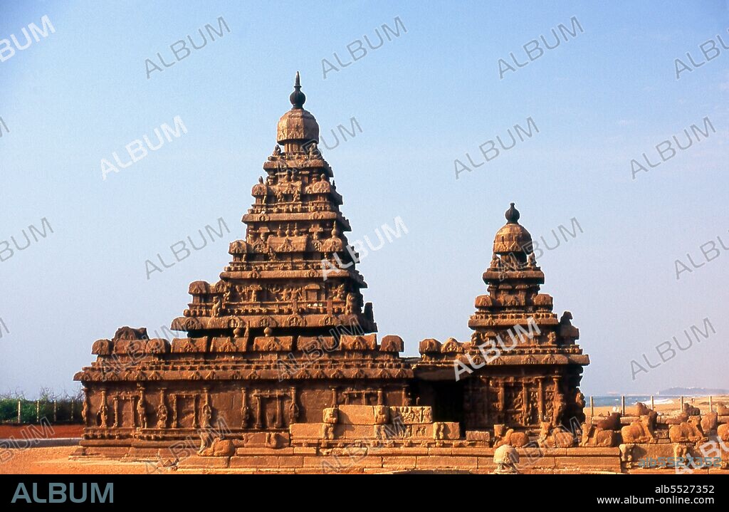 The Shore Temple was constructed in the early 8th century CE during the reign of Narasimhavarman II (also known as Rajasimha) of the Pallava Dynasty. It is so named because it overlooks the shore of the Bay of Bengal. It is a structural temple, built with blocks of granite. Mahabalipuram, also known as Mamallapuram (Tamil: ???????????) is an ancient historic town and was a bustling seaport from as early as the 1st century CE. By the 7th Century it was the main port city of the South Indian Pallava dynasty. The historic monuments seen today were built largely between the 7th and the 9th centuries CE.