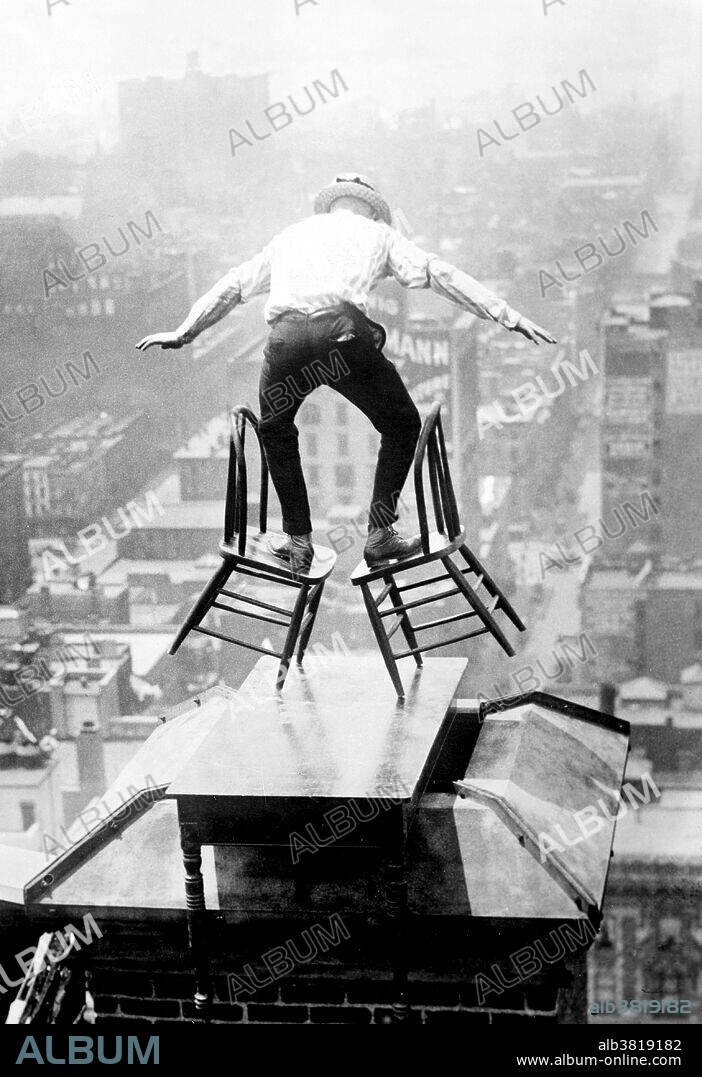"Human Fly" Reynolds on a roof in New York City. John "Jammie" Reynolds (born 1890 or 91 - ?) was an American daredevil. Little is known about early life, what became of him once he stopped performing or even his real name. An acrobat and juggler, he was known by many names - Daredevil Johnny, Daredevil Jack, the Climbing Wonder, The Lizard, the Human Spider, and the Human Fly. A newspaper article from 1922 claims he began performing at the age six in Buffalo, balancing on one foot from a flagpole 140 feet in the air. His first major stunt came at age 12 when he climbed up the side of the Old South Building in Boston, balancing atop four chairs and five tables on a plank projected over the side of the building. He gave similar performances in New York on its iconic Flatiron building, and at home in Philadelphia. Reynolds was arrested several times after his performances accused of "unlawful assembly". A stunt performer, often referred to as a stuntman, or daredevil, is someone who performs dangerous stunts, often as a career. Photographed by Bain News Service, circa 1915-20.