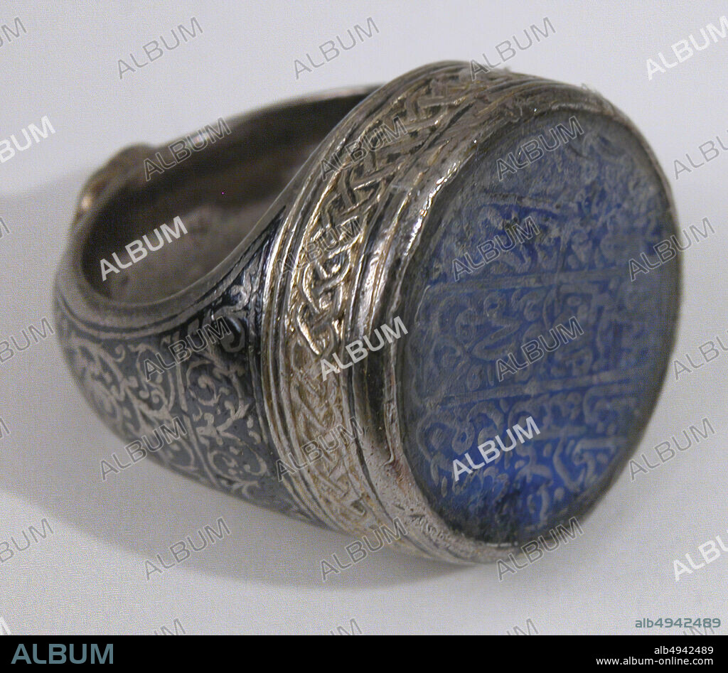 Seal Ring with the name of Hajji Muhammad ibn Mahmud, Ring, probably 16th century, Made in Central Asia or Iran, Bezel: lapis-lazuli; carvedShank: silver; worked, gilded, and with black inlay, Ht. 1 1/8 in. (2.9 cm), Diam. 1 in. (2.5 cm), Jewelry.