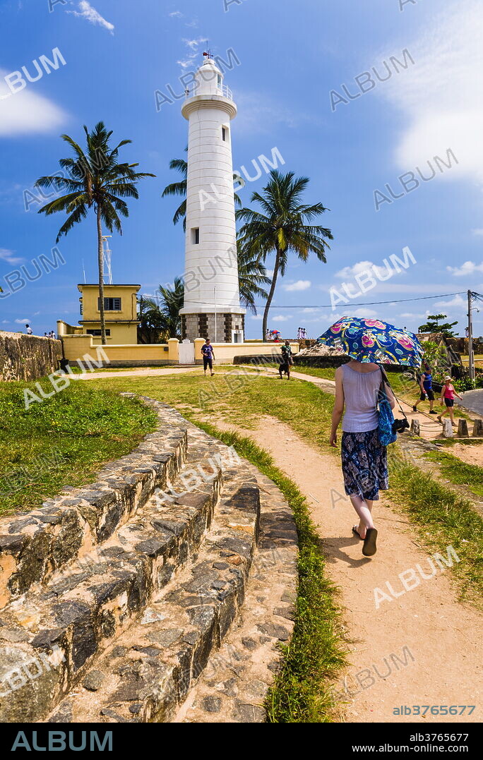 Tourist visiting Galle lighthouse in the Old Town of Galle, UNESCO World Heritage Site, Sri Lanka, Asia.