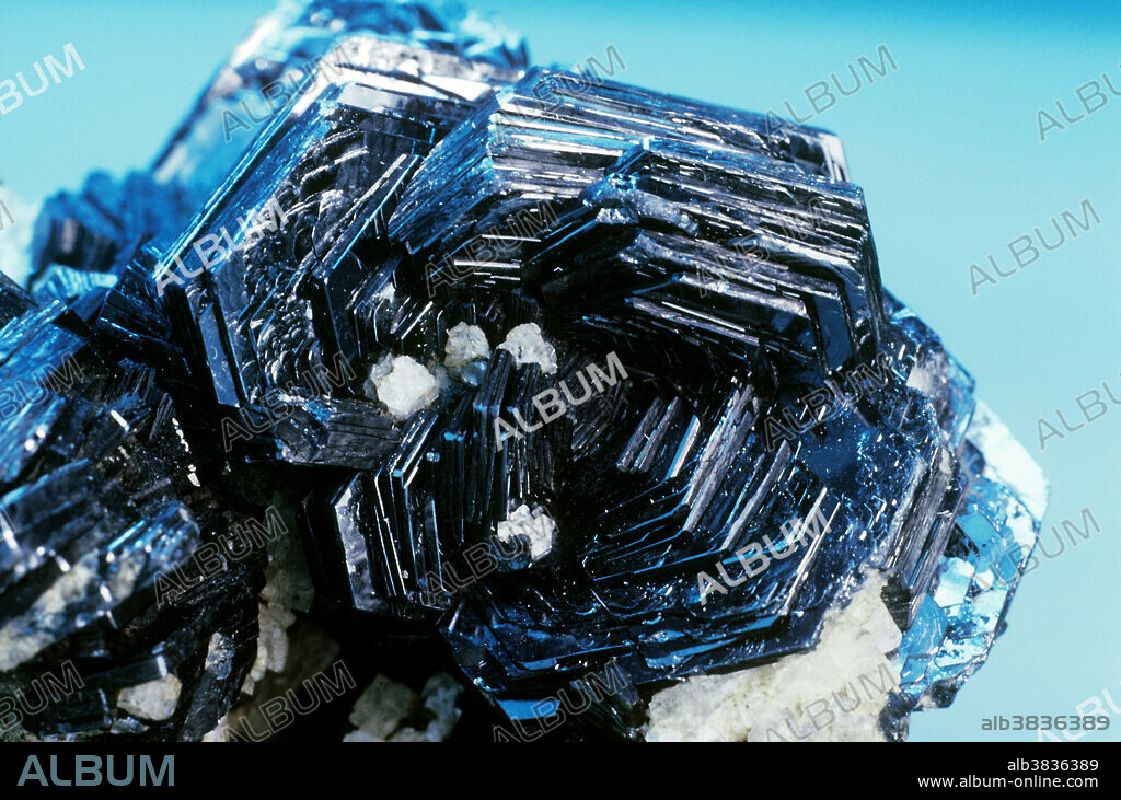Hematite is iron oxide and one of the most abundant and ubiquitous minerals on the earth's surface. It is the source of the red coloration in 'painted deserts' and the red stain seen on rocks everywhere. Although the mineral often appears black, its powder (also known as 'streak') is bright red, a useful feature in identification. Hematite can be powdery, botryoidal, banded or, as in the material from the alpine veins near Gotthard, Switzerland, crystallized. Hematite is the most important ore of iron.