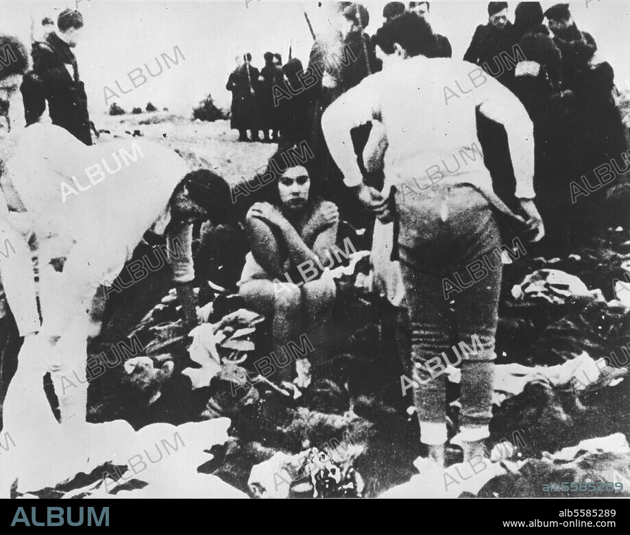 The Holocaust / Poland. Ljepaja (Latvia): Jewish women are forced to strip by SS death squads before being executed. Photo (SS member Carl Sturm), 15/12/1941.