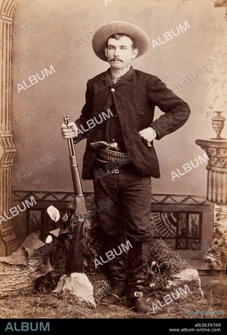 Sergeant Ira Aten Cabinet Card, circa 1889. Aten is posed standing armed with a Winchester rifle and Colt single action revolver. Aten (1862-1953) joined the Texas Rangers in 1883 at the age of twenty and was assigned to Company "D." He quickly became sergeant under Frank Jones. He gained notoriety for his participation in the "Fence Cutting Wars" of the mid- to late-1880s. In a controversial, yet ruthless, approach to the fence cutting problem, Aten placed dynamite bombs under many of the more vulnerable fences, a method which proved very effective, although the adjutant general ordered him to remove the devices. Word had spread like wildfire, however, and few outlaws risked fence cutting going forward, as the possibility of dynamite was real. He went on to serve as sheriff of Fort Bend County, Texas, and later sheriff of Castro County. He left Texas for California in 1904, dying there in 1953 at the age of ninety-one., S. Noyd, 1889.