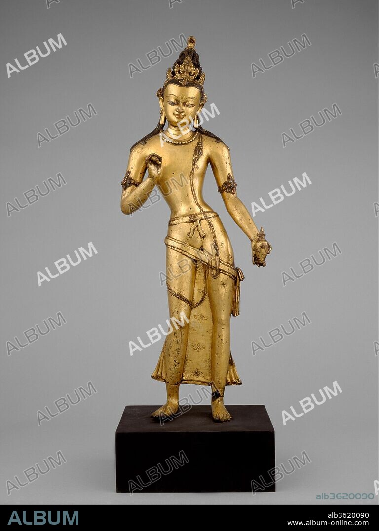 The Bodhisattva Maitreya, the Buddha of the Future. Culture: Nepal. Dimensions: H. 26 in. (66 cm); W. 8 1/4 in. (20.9 cm). Date: 11th century.
Maitreya, the messianic bodhisattva characterized as the Buddha of the Future, stands in a graciously exaggerated posture, the body beautifully counterbalanced. He holds his raised hand in the gesture of exposition (vitarka mudra) and in his lowered hand displays a flask (kamandalu) universally understood in South Asian culture as the container of amrta, the elixir of life. In a Buddhist setting, the flask is understood as the promise of Maitreya's coming. The elegant aesthetics of this sculpture embody contemporary eastern Indian Pala styles, yet it displays a startling elegance combined with an almost austere economy of surface decoration: jewelry is restrained, textile patterns minimally suggested. The scale is exceptional, as is the aesthetic sensibility of the artist responsible for this work.