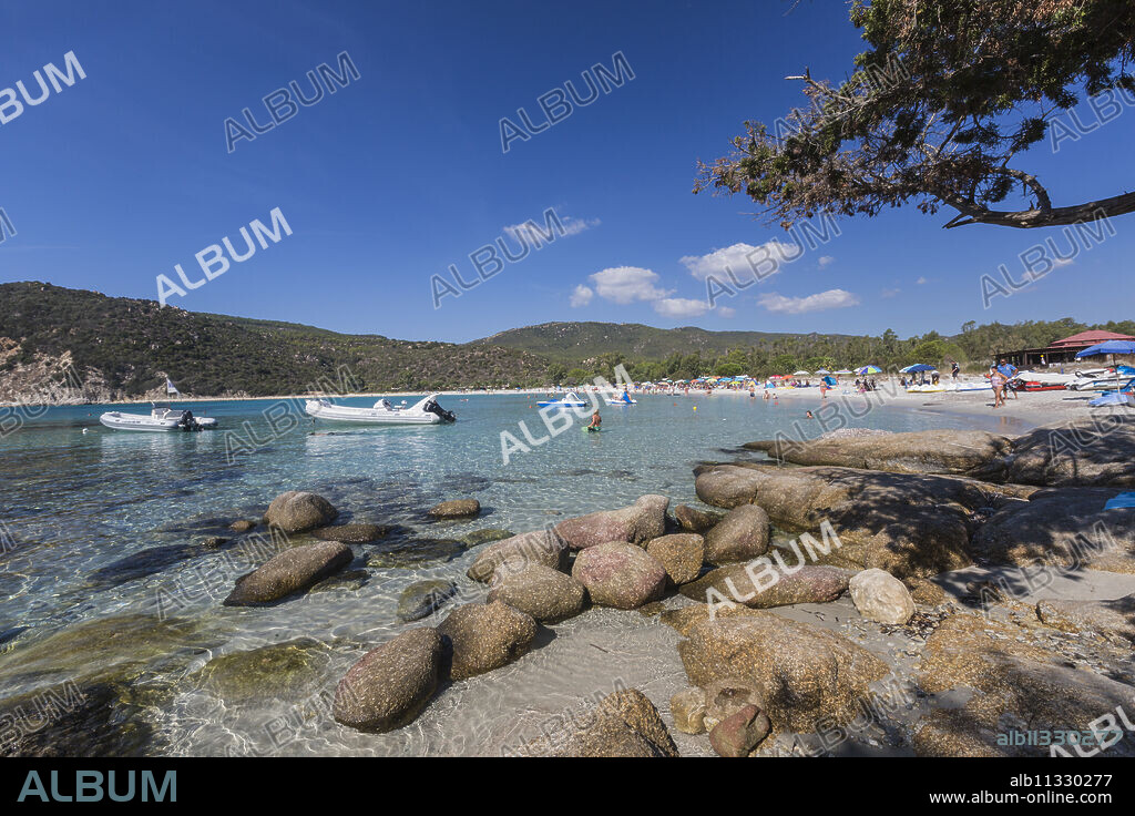 Boats in the turquoise sea surround the sandy beach of Cala Pira Castiadas, Cagliari, Sardinia, Italy, Mediterranean, Europe.