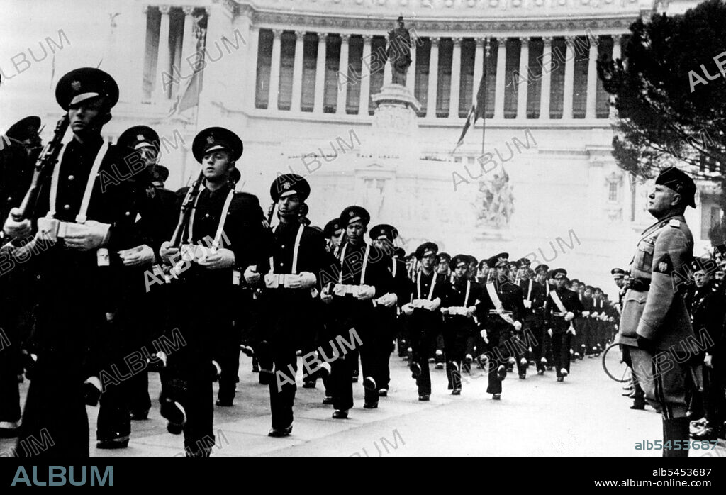19th Anniversary Of Foundation Of Fascism.Signor Mussolini Photographed in the Piazza Venezia, watching the march past of students of the Rome military school, doing the "Roman Step" the Italian version of the German goose step. The occasion was the nineteenth anniversary of the foundation of Fascism. In the background is the unknown Warrior's toms. March 25, 1938. (Photo by Keystone).