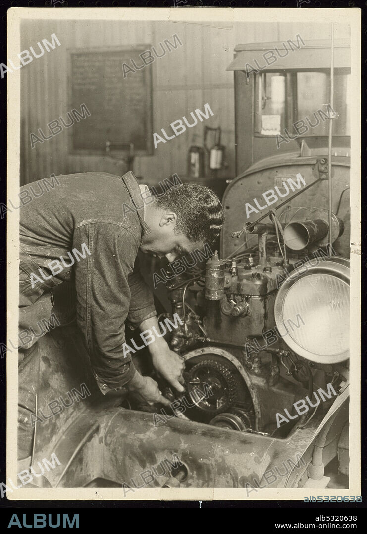 LEWIS WICKES HINE. A gelatin silver print of a man working on engine at the Manual Training and Industrial School for Colored Youth in Bordentown, New Jersey. The Bordentown boarding school for African-American students was founded in 1886. It was known as the "Tuskegee of the North" for its adoption of many of the educational practices first developed at the Tuskegee Institute in Alabama.