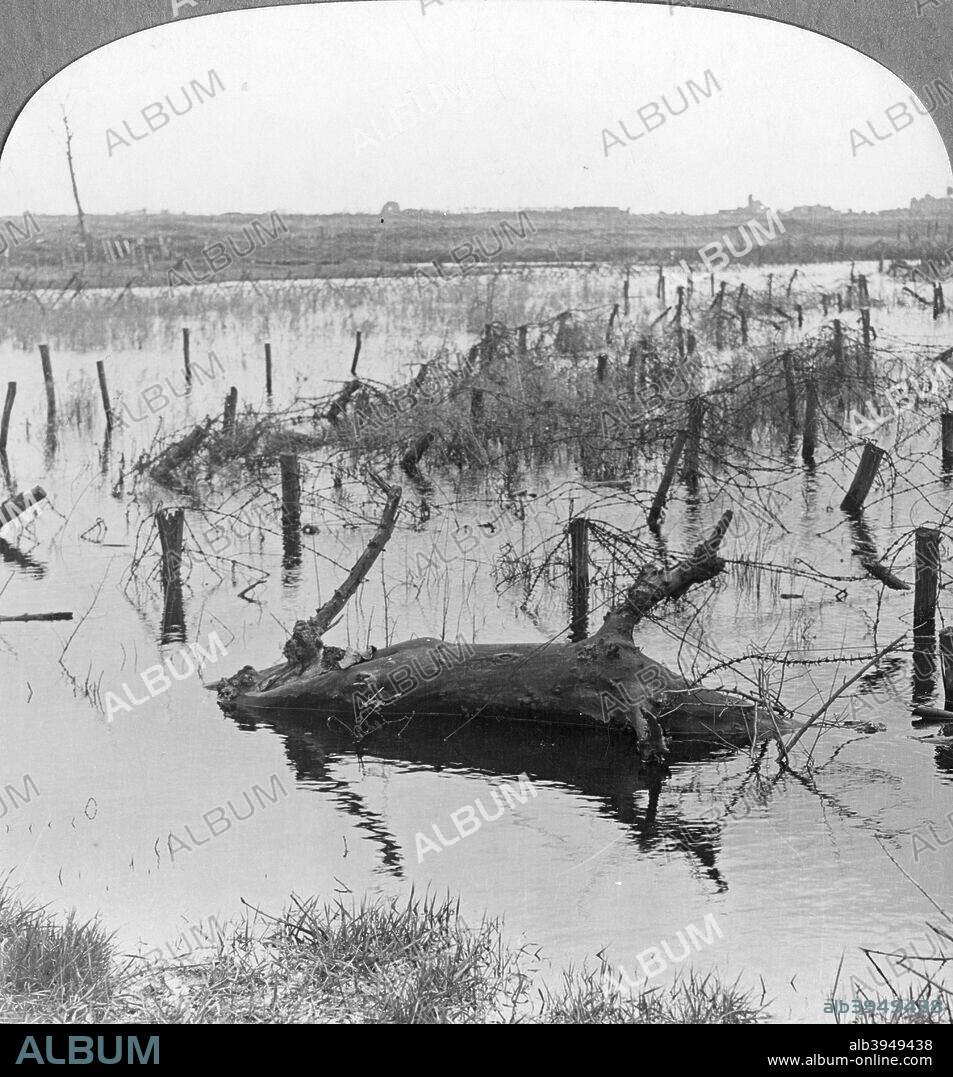 Opened sluices and barbed wire at Nieuwpoort, Belgium, World War I, c1914-c1918. During the Battle of the Yser in 1914, the Belgians opened the sluice gates at the mouth of the River Yser in order to flood the low-lying land and stop the advancing German Army. Stereoscopic card. Detail.
