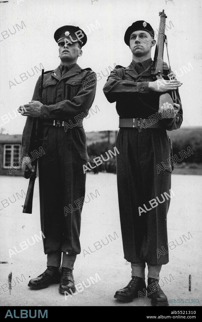 New Rifle Drill For British Army - "The Old and the New" on the left is the lefthanded salute with the new rifle at the shoulder arms, in contrast with the right-handed salute with the old rifle at the "slope" (seen on right).A demonstration of proposed alterations in drill caused by the adoption of the self-loading Belgian F.N. 30 rifle for the British Army, was given at the School of Infantry at Warminster, Wiltshire.The drill was demonstrated by squads of the 1st Battalion Wiltshire Regiment and recruits form the Guards Depot, Caterham, Surrey. December 13, 1954.