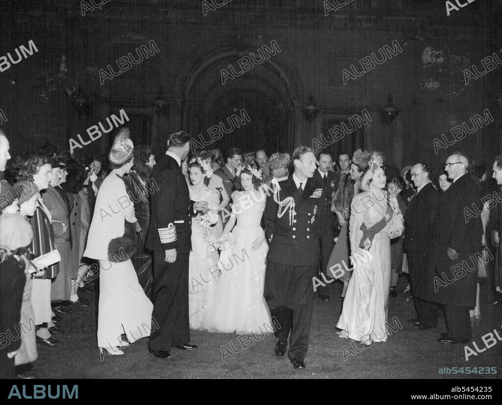 Royal Couple Leave For Honeymoon -- The King and Queen with Frederik and Queen Ingrid (Left turning to smile at Princess Margaret and Princess Alexandra of Kent). walking back to the Palace after saying Good-bye to the Honeymoon Couple. The Royal family and guest later went to Waterloo. The Queen wears the sash of the Order of the Garter. Princess Elizabeth and her bridegroom, the Duke of Edinburgh (The Former Lieutenant Phillip Mountbatten) drove in Procession through wildly Cheering crowds from Bukingham Palace to Waterloo Station en Route to Broadlands, Hampshire, The King and Queen and other Royal Wedding guests accompanied them to Waterloo. November 20, 1947. (Photo by Planet News Ltd.).