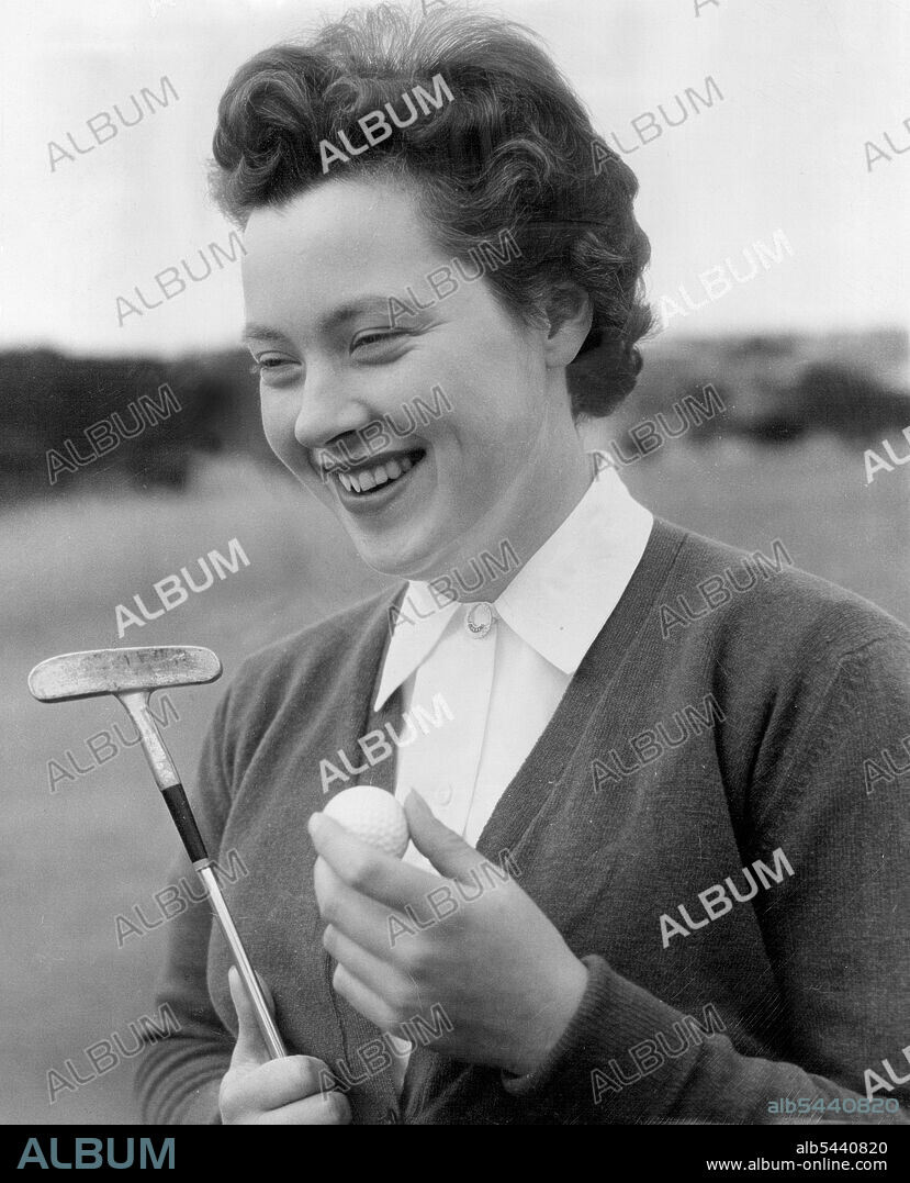 English women golfer Veronica Anstey. Miss Veronica Anstey, a member of the British women's junior golf team touring Australia. She won the recent Victorian championship. Miss Anstey is shown with the putter that helped he win the title. It is a "dead centre" shafted club with a copper coated mild steel head. the club was found among dozens of discarded sticks when the tourists visited Bill Edgar's home in Melbourne. Miss Anstey tried it and liked it and Edgar gave it to her. the British team will play NSW at Royal Sydney on Saturday. August 25, 1955.