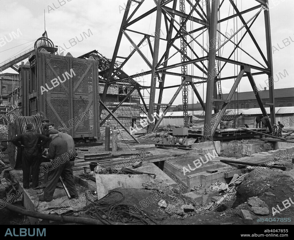 Installing a cage at Hickleton Main pit, Thurnscoe, South Yorkshire, 1961. During the drive to improve the pits in the South Yorkshire area during the 1950s and 1960s, the National Coal Board undertook many large projects. In this photograph, engineers from Norwest Constructon are preparing to install a cage in the coal winder at the Hickleton Main colliery.