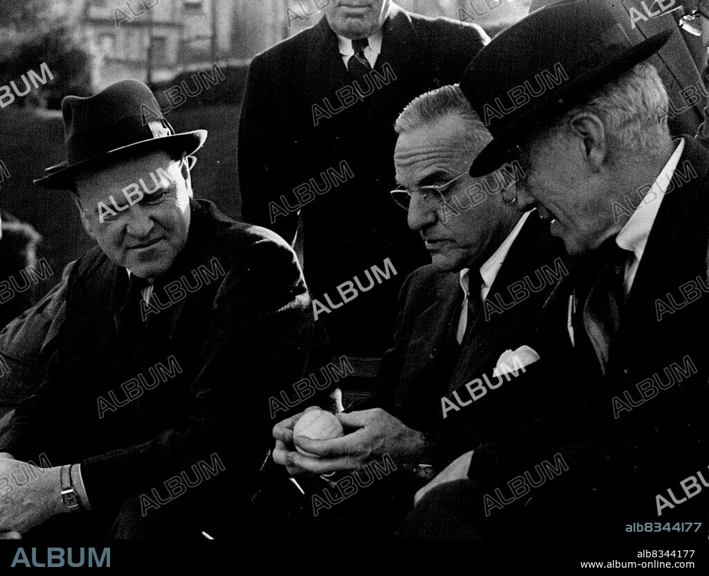 Non-playing Davis Cup captains Gerald Patterson (Australia) left, and Walter Pate (US), center, discuss the brand of tennis ball to be used in the Challenge Round with ALTA president, Sir Norman Brookes. November 24, 1946.