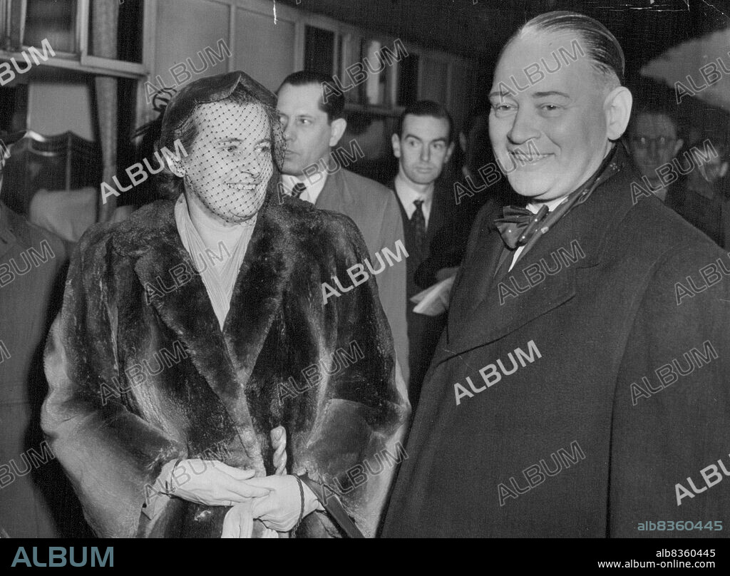 New Dutch Ambassador Arrives -- Dr. Dirk Stikker, the new Dutch Ambassador, and his wife, pictured on their arrival at Liverpool Street Station this morning.***** Appointment of Dr. Dirk U. Stikker as Secretary-General for ***** the North Atlantic Treaty Organisation has brought into ***** international limelight a man who, less prominently but always *****, has for many years served the cause of Western unity. October 23, 1952.